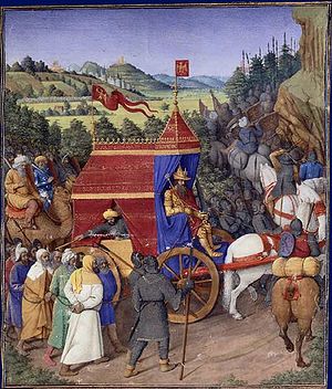 Enluminure montrant un roi dans un chariot au milieu de ses troupes, avec des captifs marchant à côté du chariot