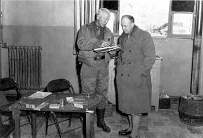 General Patton (left) confers with General Eisenhower at the beginning of the II Corps offensive. (DA photograph)
