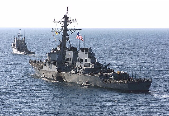 USS Cole is towed away from the port city of Aden, Yemen, into open sea on October 29, 2000.