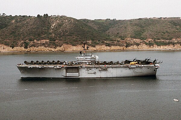 USS New Orleans underway with a complement of CH-53 Sea Stallion and CH-46 Sea Knight helicopters lining the flight deck.