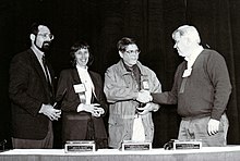 At the USENIX conference in 1996, Steve Johnson(r), then President of USENIX, presents the "Lifetime Achievement Award (The Flame)" to Joe Sventek (l), Deborah Scherrer (2nd from left), and Dennis Hall. Usenix Flame Award presented to Hall, Scherrer, Sventek for STUG-1996.jpg
