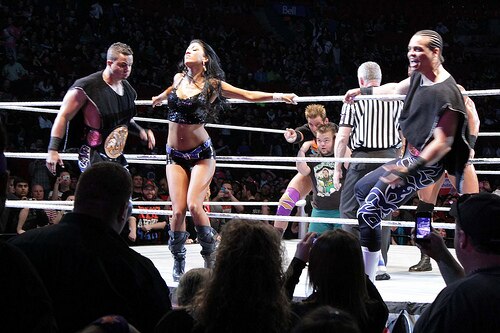 Epico with (far right) Primo (left) and Rosa Mendes as the WWE Tag Team Champions