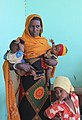 A woman pictured with her children, recovering from malnutrition at a health clinic in southern Ethiopia (6021951300).jpg