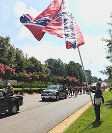 Georgia Flagger with large flag on 20 foot pole at Alpharetta Old Soldiers' Parade, Alpharetta, Georgia, August 4, 2018. Bearden at Alpharetta Aug 2018.jpg