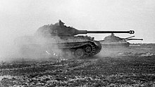 Tiger IIs (with the early production turret) on the move in northern France, June 1944 Bundesarchiv Bild 101I-721-0397-34, Frankreich, Panzer VI (Tiger II, Konigstiger) crop.jpg