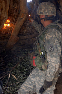 A Soldier from Charlie Company 2nd Battalion, 87th Infantry Regiment sets fire to a Taliban safe house discovered during Operation Catamount Fury, the Paktika Province of Afghanistan Burning a safe house, -c.jpg