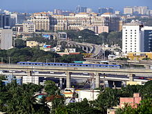 Grand Chola (centre), amidst surrounding buildings Chennai metro during trail run.JPG