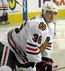 Hockey player warms up prior to a game as he intensely looks at the camera