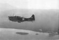 A Marine Dive Bomber from VMSB-144 turns gently toward the beachhead area prior to peeling off in one of the prelanding airstrikes at Torokina on D-Day morning