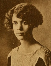 A young woman with dark wavy hair cut in a side-parted bob