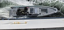 FSK during training in the Oslofjord, entering a ferry by telescopic ladder FSK training, alongside the ferry, about to start raising the telescopic arm.jpg