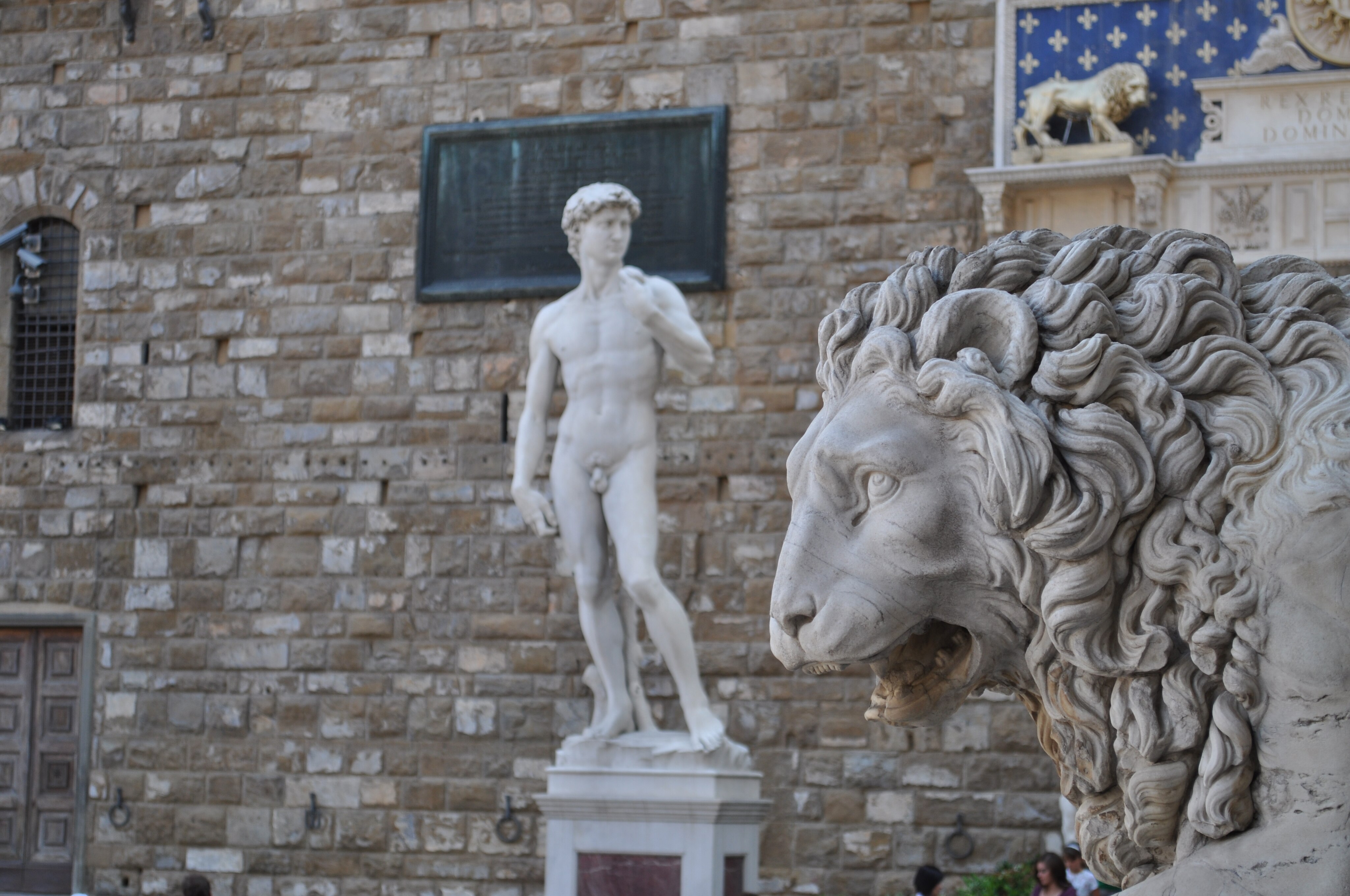 One of the lions under the Loggia dei Lanzi, and Michelangelo's David, Piazza della Signoria in Florence