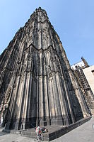 Sleeping homeless person in the corner of Cologne Cathedral, Cologne, North Rhine-Westphalia, Germany, 2010.