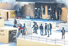 Iraqi Police outside the smoldering outer perimeter of the U.S. embassy, 1 January 2020 Iraqi Soldiers US embassy 2020.jpg