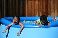Children playing in an inflatable pool