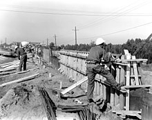 Hurricane protection floodwalls are installed along the Inner Harbor Navigation Canal in 1968.