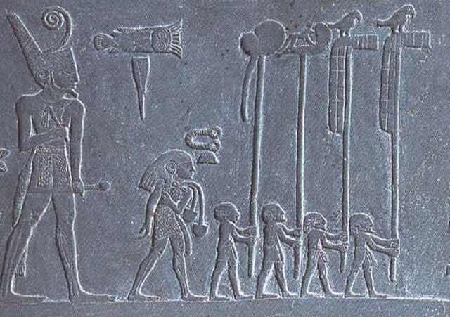 Narmer, a Predynastic ruler, accompanied by men carrying the standards of various local gods