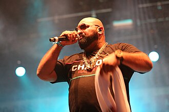 German rapper Xatar (pictured in 2016) co-wrote "Ich liebe es" and appeared as a featured rapper. Out4Fame-Festival 2016 - Xatar.JPG