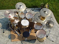 A seven-piece kit typically used for heavy metal, jazz fusion, and progressive rock, consisting of double bass drums, two-floor toms, and an extended set of cymbals (three crashes with splash and China-type). OutsideBRX-15.JPG
