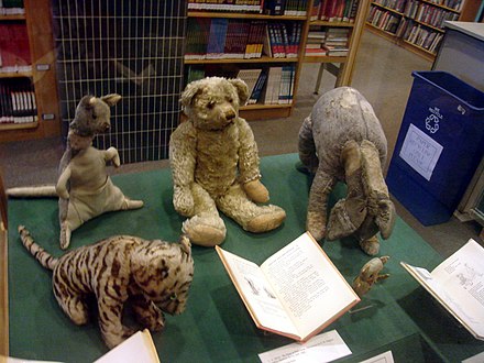 These stuffed animals are the ones that belonged to Christopher Robin Milne, upon which the stories were based. They are on display in the Donnell Library Center in New York City. The tiger became Tigger, the kangaroo Kanga, the bear Winnie-the-Pooh, the piglet Piglet, and the donkey Eeyore. The kangaroo came with a baby that inspired Roo, but Christopher Robin lost the toy at a young age. Noticeably absent are Owl and Rabbit; these two characters were made up for the stories by the author.