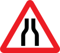 Road narrows on both sides