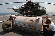 US Navy 040422-N-9849W-044 Members assigned to the War Lords of Light Helicopter Anti-Submarine Squadron Five One (HSL-51) remove bolts from a case containing a new engine.jpg
