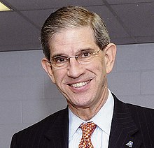 Smiling man with glasses wearing suit