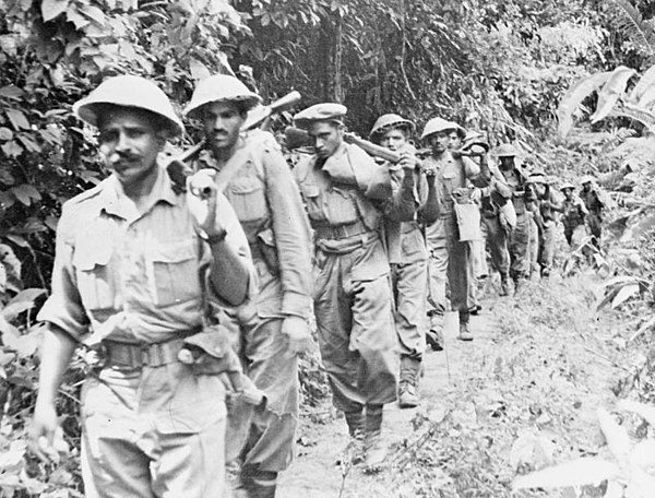 Men of a Punjab Regiment march out of the jungle near Pyagle, Burma, 1945.