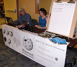 Campus Ambassador Mike Cline and MSU Bozeman Wikipedia student club member Autumn LaBuff teach interested people about Wikipedia at a table in the student union building at Montana State University.