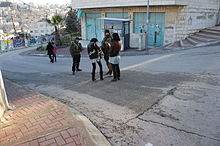 Palestinian girls having their school bags searched by Israeli soldiers in Tel Rumeida, Hebron 2012.01.16.HebronGilbertCheckpoint.1.JPG