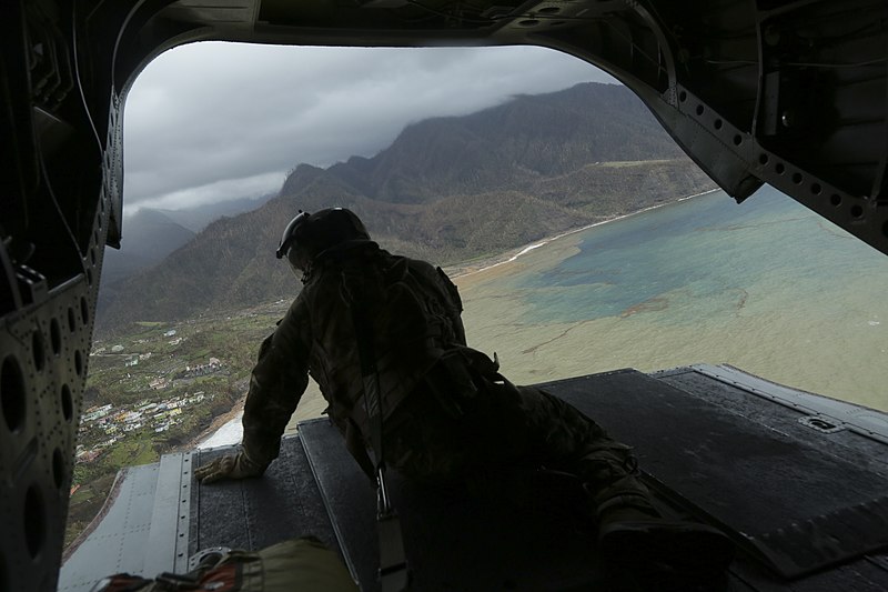 File:20 Sept 2017. RAF Master of Aircrew, Vince Bartlett, looks out from the back of a Chinook helicoprt during a needs assessment mission to the Island of Dominica. (37188609672).jpg