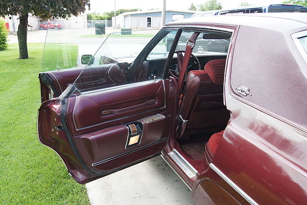 1976 Chrysler New Yorker with doors open. Note the absence of a driver's vent window and half-height pillar to which the rear doors attach.