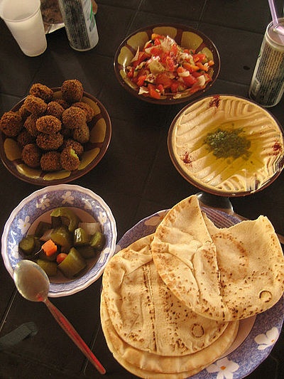 A typical Jordanian breakfast. Hummus, falafel, salad, pickles and khubz (pita)