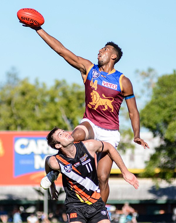 A ruckman leaps above his opponent to win the hit-out during a ball-up