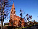 Village church with monument to the fallen and fencing