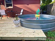 Stock tanks can be repurposed as backyard pools, or "stock tank pools," using chlorine tabs and a filter pump Backyard Stock Tank Pool.jpg