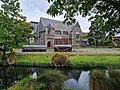 The earthquake-damaged Bellamy's building viewed across the Avon River - Oxford Terrace. January 2023