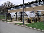 Enclosed, lockable bicycle shelter, at a school in West Midlands of England.