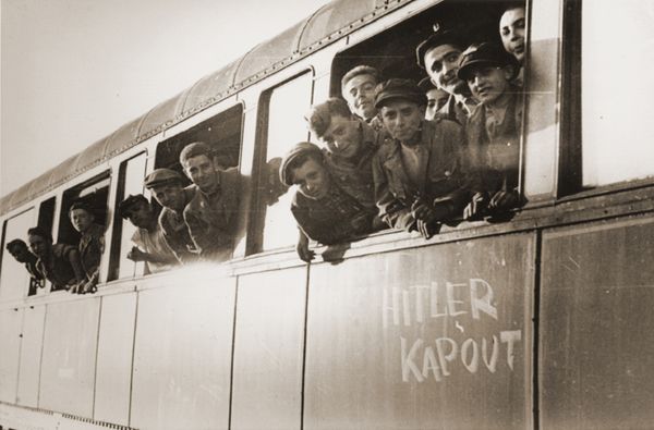 Jewish youth liberated at Buchenwald lean out a train marked Hitler kaput ("Hitler [is] finished") en route to an OSE home in Ecouis, France.