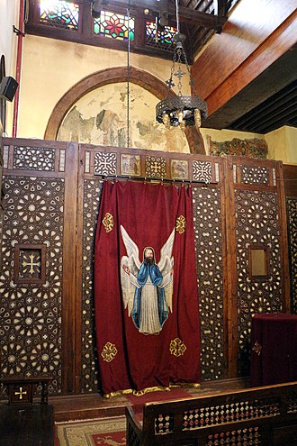 Side chapel in the Hanging Church in Old Cairo, including frescoes (partly visible behind the screen here) dating from the late 12th or 13th century, before the church's later renovation Cairo, chiesa sospesa, interno, iconostasi.JPG