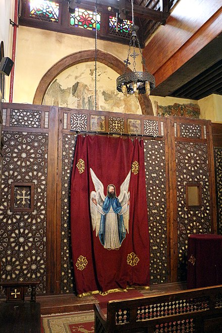 Side chapel in the Hanging Church in Old Cairo, including frescoes (partly visible behind the screen here) dating from the late 12th or 13th century, before the church's later renovation[195]