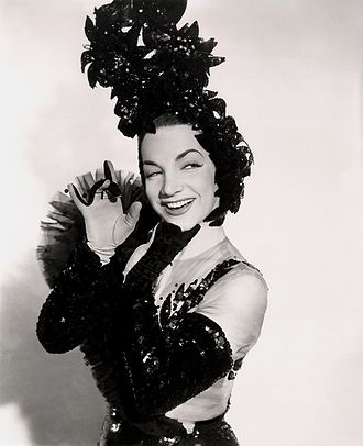 Carmen Miranda was the first samba singer to promote the genre internationally. Carmen Miranda (1944).jpg