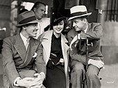 Cesar Romero, Fay Wray, director Richard Thorpe and cinematographer George Robinson (in background) on the set Cheating Cheaters (1934) set 1.jpg