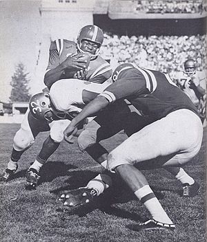 Clay White attempts an end run during a 1959 game. Clay White (1959 Nebraska football).jpg