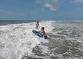 English: Playing in waves at the beach near Great Island Cabins at Core Banks, North Carolina