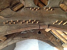 The roof above the great chamber, with arch-braced collar trusses joined using "double pegging" Detail of roof of Plas Mawr.JPG