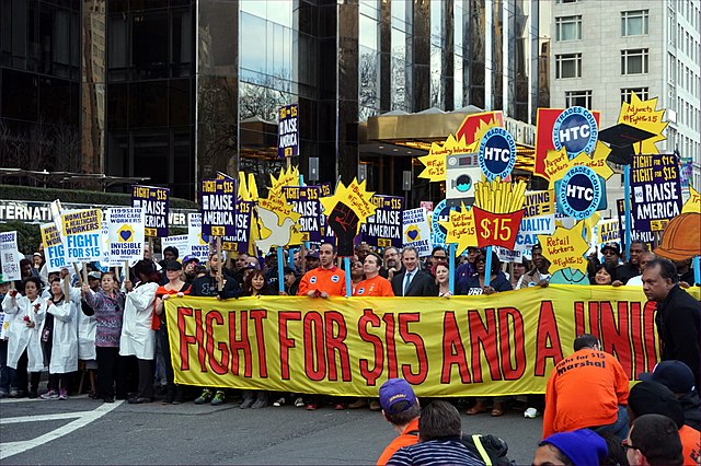 Protesters call for an increased legal minimum wage as part of the "Fight for $15" effort to require a $15 per hour minimum wage in 2015. A government