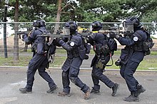 GIGN operators forming an assault column