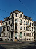 Apartment house in a corner and open development