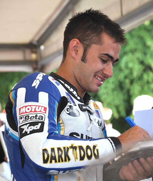 Haslam signing an autograph at Goodwood Festival of Speed in 2010 wearing Alstare Suzuki World Superbike team colours